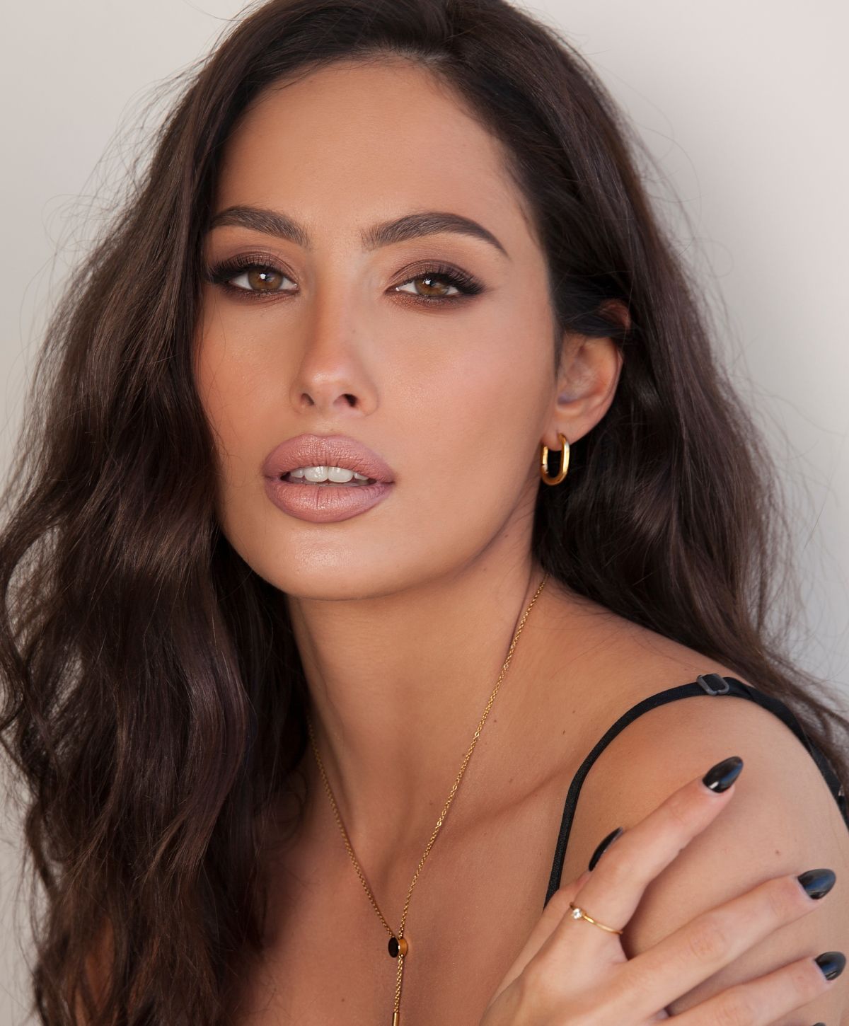 Woman with shoulder-length hair and striking features.