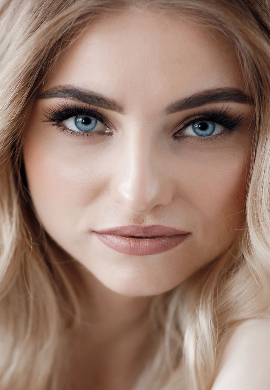 Close-up portrait of a woman with blue eyes.
